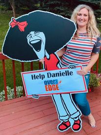 Photo of Danielle with Gilda cartoon cutout for Over the Edge fundraiser
